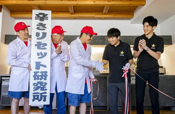 握手を交わすサッポロビール吉田さん(右)と江口所長(左)